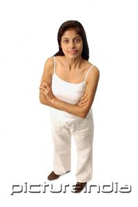 PictureIndia - Woman standing, arms crossed, looking at camera