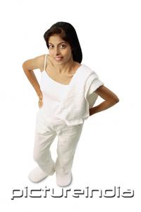 PictureIndia - Woman standing with hands on hip, towel on shoulder