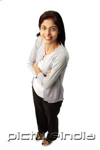 PictureIndia - Woman smiling at camera, arms crossed