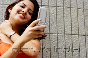PictureIndia - Woman looking at mobile phone, smiling
