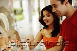 PictureIndia - Couple looking at jewellery display in shop window