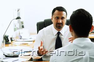 PictureIndia - Two businessmen in office having a discussion