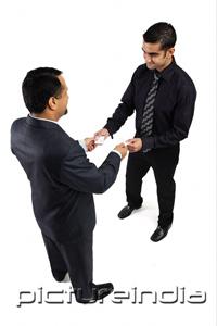 PictureIndia - Two businessmen exchanging namecards