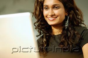 PictureIndia - Woman looking at laptop