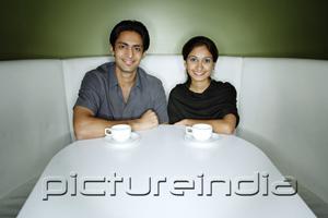 PictureIndia - Couple sitting side by side looking at camera
