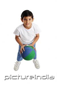 PictureIndia - Boy holding basketball, facing forward
