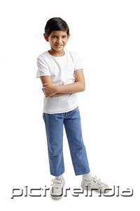 PictureIndia - Boy standing looking at camera, arms crossed