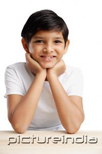 PictureIndia - Boy with hands on chin, smiling