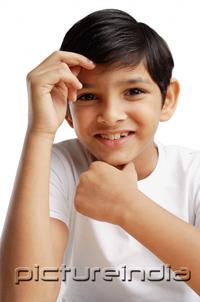 PictureIndia - Boy with hand on chin, smiling