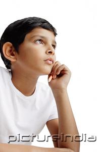 PictureIndia - Boy with hand on chin, looking away