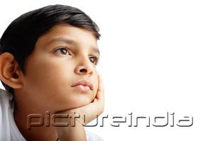 PictureIndia - Boy with hand on chin, looking away