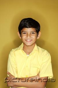 PictureIndia - Boy looking at camera, arms crossed