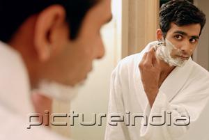 PictureIndia - Man in bathroom, shaving his face