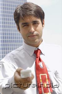 PictureIndia - Businessman holding mobile phone towards camera