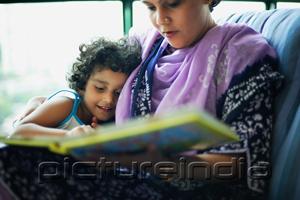 PictureIndia - Mother and daughter sitting down at home going through photo album