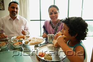 PictureIndia - Family of three sitting down to a meal