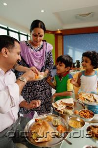 PictureIndia - Family of four having a meal at home