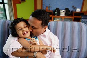 PictureIndia - Father embracing daughter, kissing her on cheek