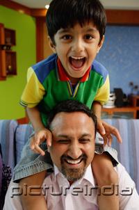 PictureIndia - Father carrying son on shoulders