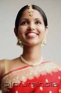 PictureIndia - Woman in traditional Indian attire smiling, head shot