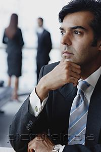 PictureIndia - Businessman looking away, hand on chin