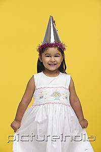PictureIndia - Young girl in white dress and party hat